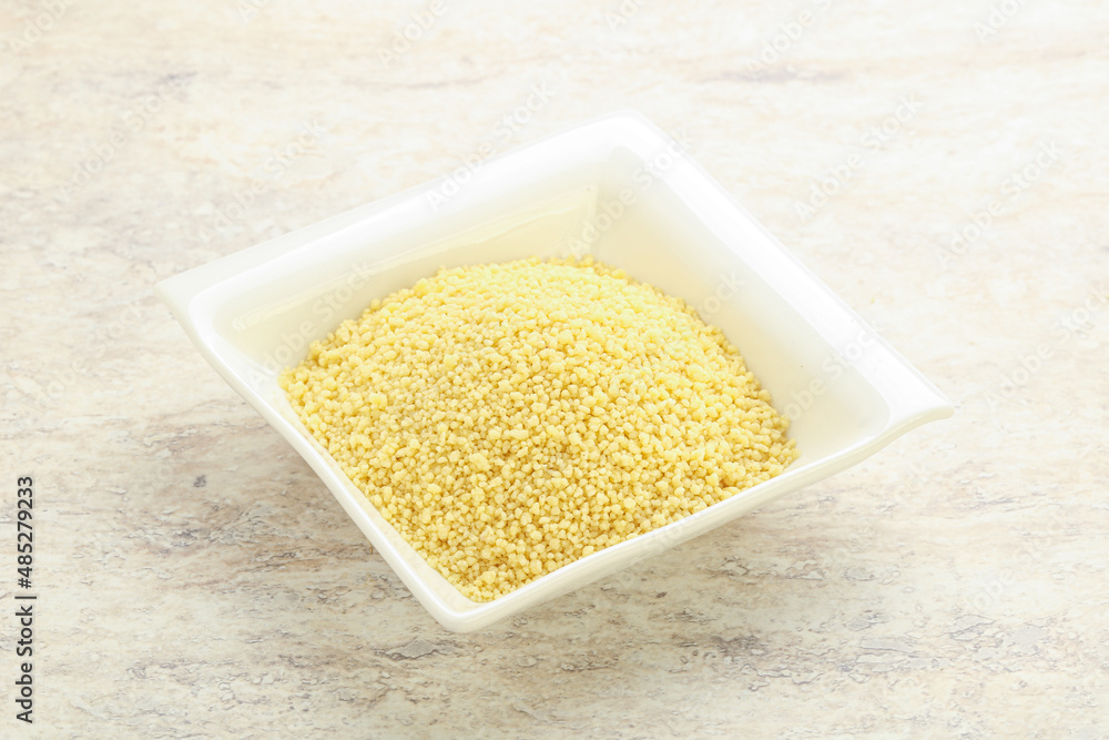 Raw couscous in the bowl Raw couscous in the bowl