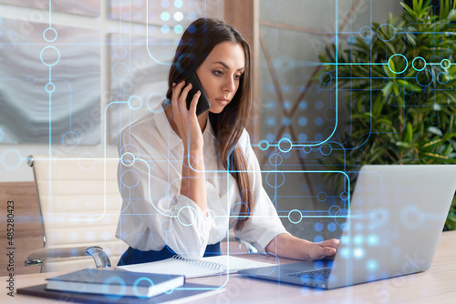 фотографія Attractive businesswoman in white shirt has conference call to optimize development by implying new technologies in business process