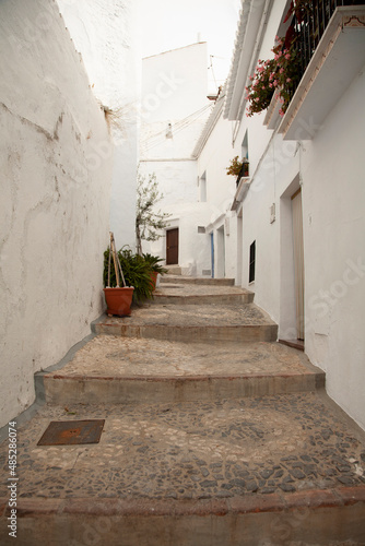 Typical streets of Frigiliana. White houses, flowers, cobbled streets and magical corners. © RaquelMaria
