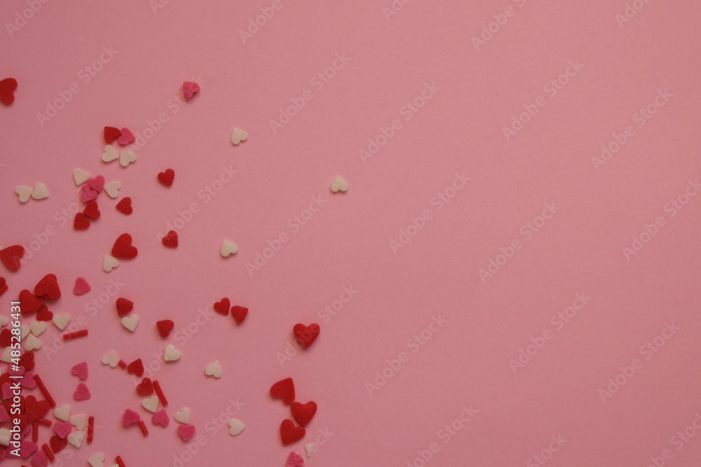 pink background with sprinkles hearts with space for text