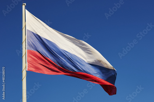 Photography The national flag of the Russian Federation flutters in the wind against a blue cloudless sky