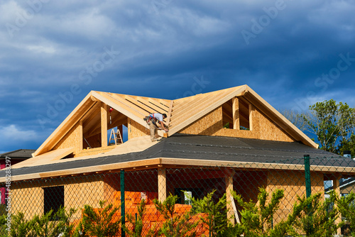 A worker building a passivhaus house with wood photo