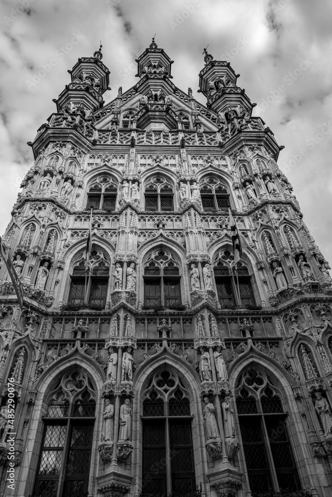 Black and white frontal perspective. Travel photograph, street view in a beautiful sunny September day with some clouds, Leuven, Belgium
