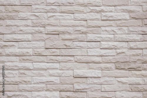 Cream and white brick wall texture background. Brickwork and stonework flooring interior rock old pattern