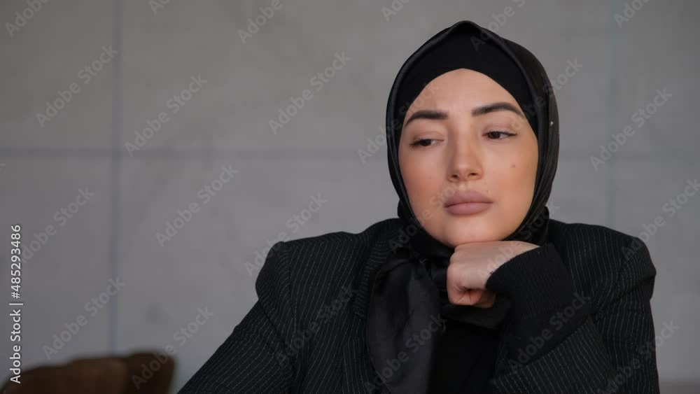 Thoughtful concerned business Young Muslim arabian woman in hijab thinking solving problem in office. Planning, research or brainstorming at cafe. Arabian religious woman. Thoughtful concerned business Young Muslim arabian woman in hijab thinking solving problem in office. Planning, research or brainstorming at cafe. Arabian religious woman.