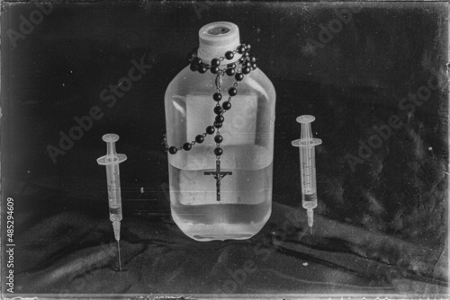 Bottle in the meddle with rosery and two needles with both sides, old black and white images