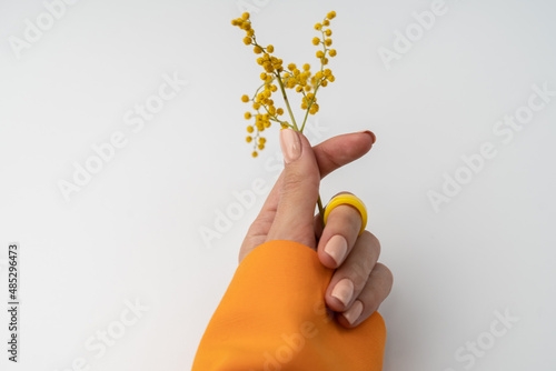 Photography Close shot of a thin graceful hand of a girl with a nude spring trendy manicure