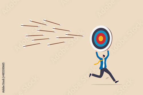 Chasing for target achievement, guidance or control to reach goal, competition or challenge to success, aiming or motivation concept, businessman holding big arrow target run away from bunch of arrow.