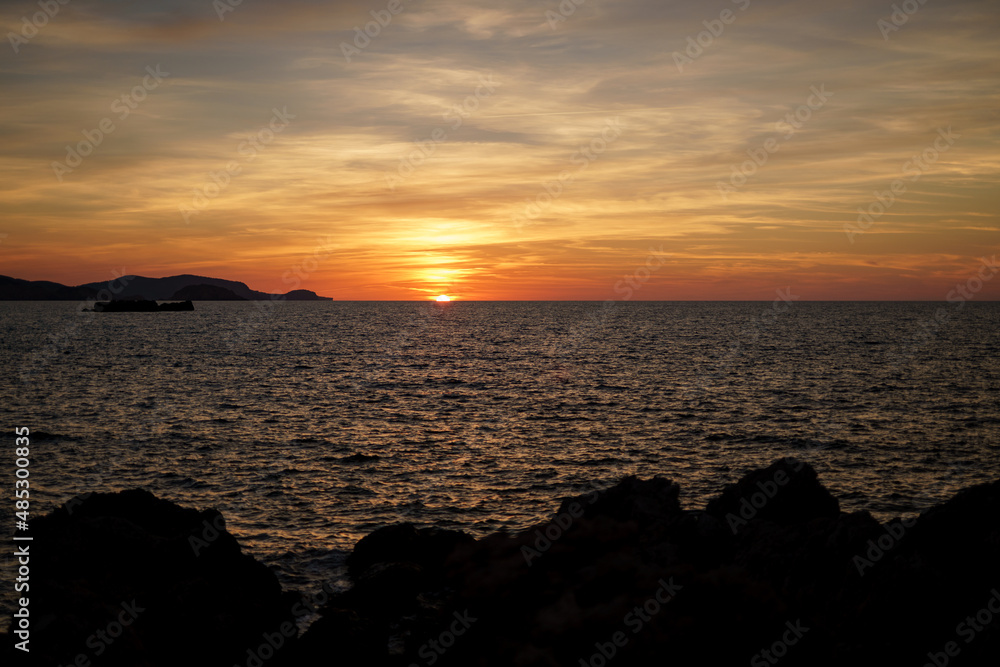 Cala Viola de Ponent, Menorca. September 2021. Magnificent sunset in the Mediterranean Sea. On one of the paradisaical beaches of the island of Menorca. Cala Viola de Ponent, Menorca. September 2021. Magnificent sunset in the Mediterranean Sea. On one of the paradisaical beaches of the island of Menorca.
