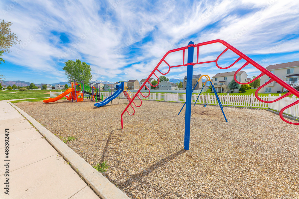Playground with hanging bars, slides, and swings in a community at Utah Playground with hanging bars, slides, and swings in a community at Utah