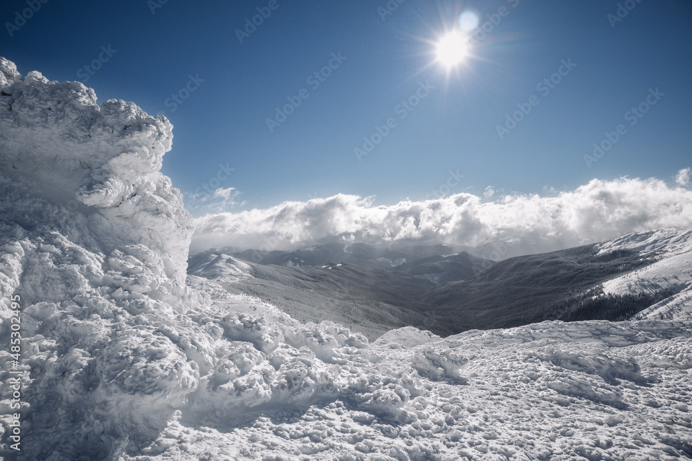 High in the mountains, a large piece of ice merges with the clouds