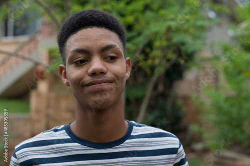 Close up portrait of happy teenager standing outdoors