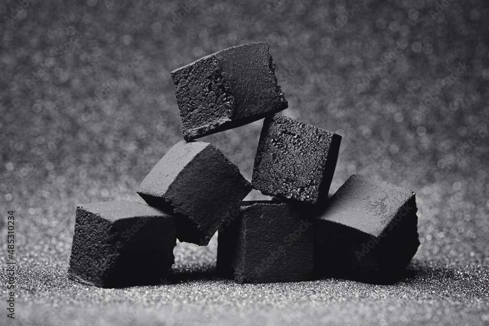Coal for hookah. Coal for a hookah on a gray background. Stock Photo