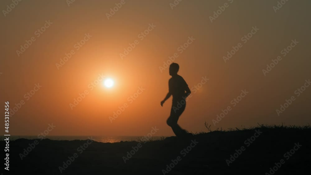 one healthy active male running on summer sunset shore during sport lifestyle activity
one healthy active male running on summer sunset shore during sport lifestyle activity