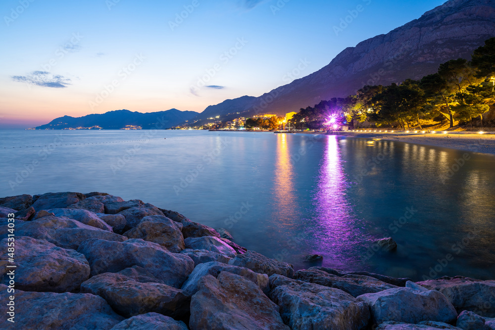view on Baska Voda town at evening with Biokovo mountains in Dalmatia in Croatia