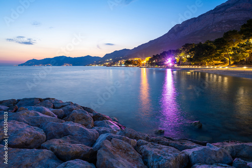 Obraz na płótnie view on Baska Voda town at evening with Biokovo mountains in Dalmatia in Croatia w salonie