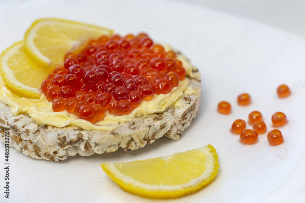 Crispy wheat crackers with red caviar, spread and lemon. Natural Diet Bread Crispy wheat crackers with red caviar, spread and lemon. Natural Diet Bread