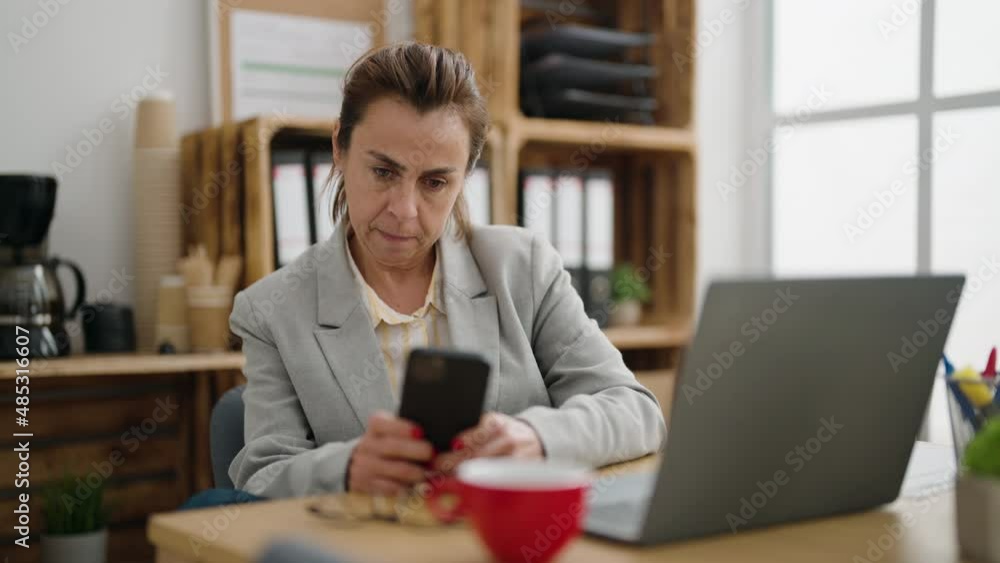Middle age woman business worker using smartphone at office Middle age woman business worker using smartphone at office