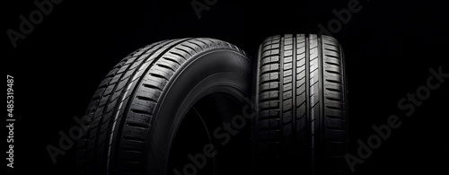 new beautiful tires on a black background, tire change season photo