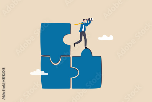 Finding solution or search for last missing piece to finish or complete work, leadership mission or business difficulty concept, businessman standing on uncompleted jigsaw looking for missing piece. photo