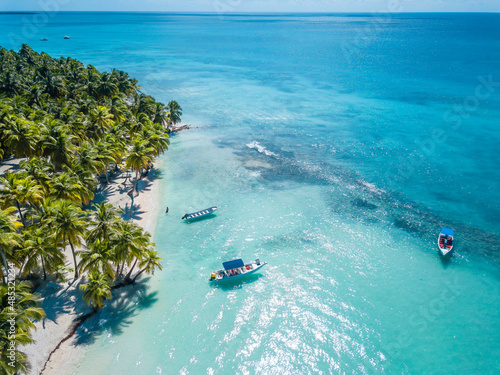 Aerial view of Saona Island in Dominican Republuc. Caribbean Sea with clear blue water and green palms. Tropical beach. The best beach in the world. photo