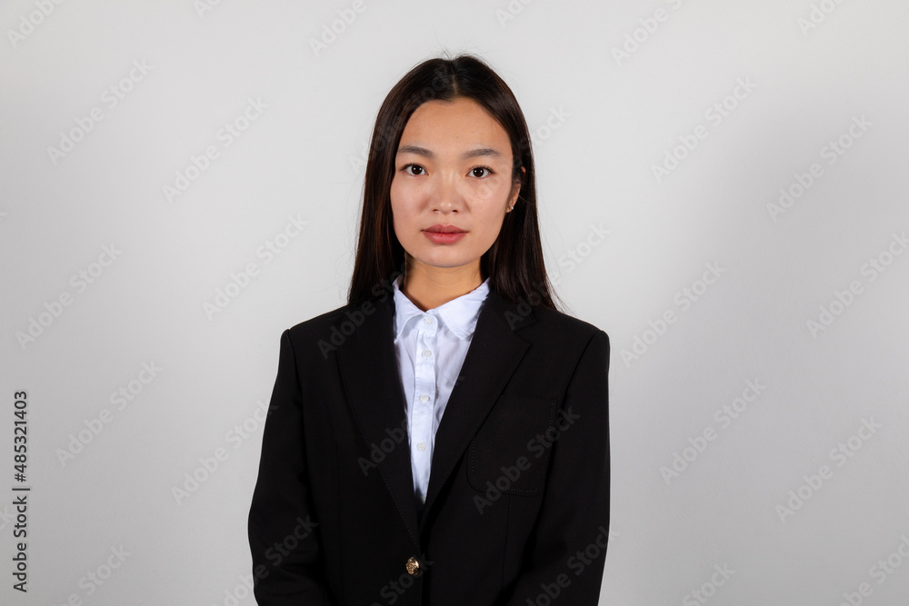 Portrait of a serious young asian business woman wearing a black suite Portrait of a serious young asian business woman wearing a black suite