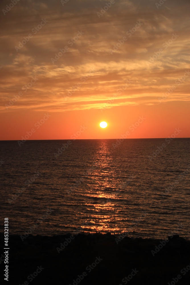 夕日に照らされた海の写真素材