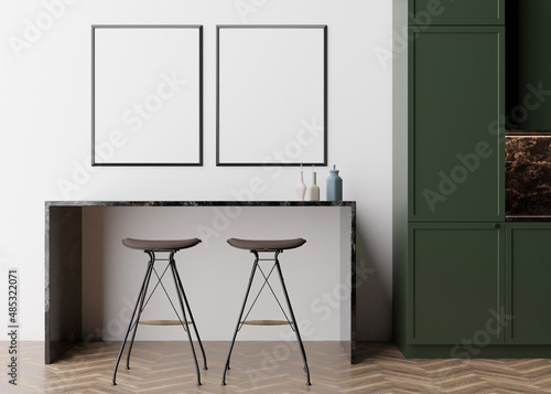 Two empty vertical picture frames on white wall in modern kitchen. Mock up interior in minimalist, contemporary style. Free space, copy space for your picture, poster. Table, chairs. 3D rendering.