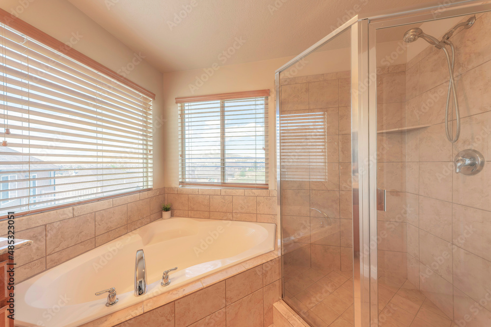Corner bathtub and shower stall with ceramic tiles surround Corner bathtub and shower stall with ceramic tiles surround