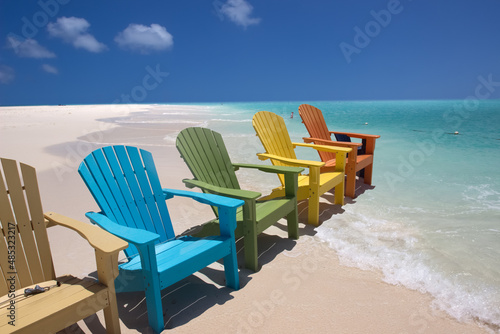 Colorful beach chairs on caribbean coast © elvirkin