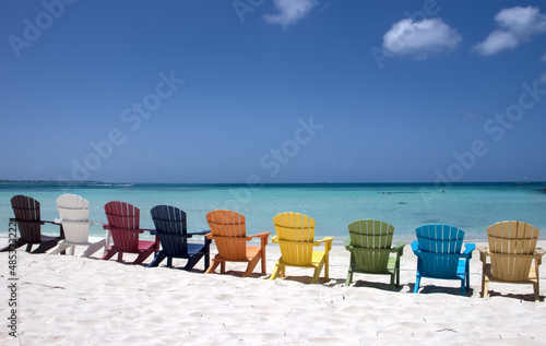 Colorful beach chairs on caribbean coast © elvirkin