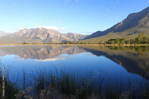 Fototapeta Naklejka Na Ścianę i Meble -  Mountains reflected in a farm dam near Worcester, South Africa.