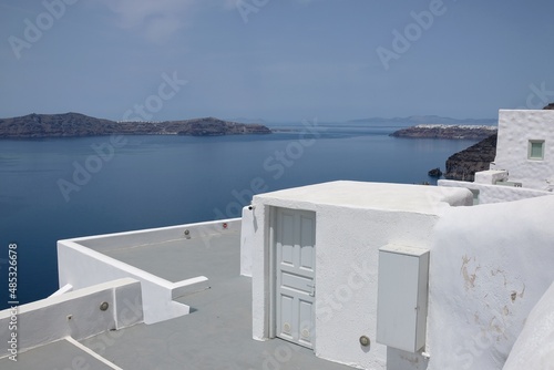 View of traditional whitewashed buildings in front of the beautiful aegean sea in Fira Santorini Greece © DIMITRIOS