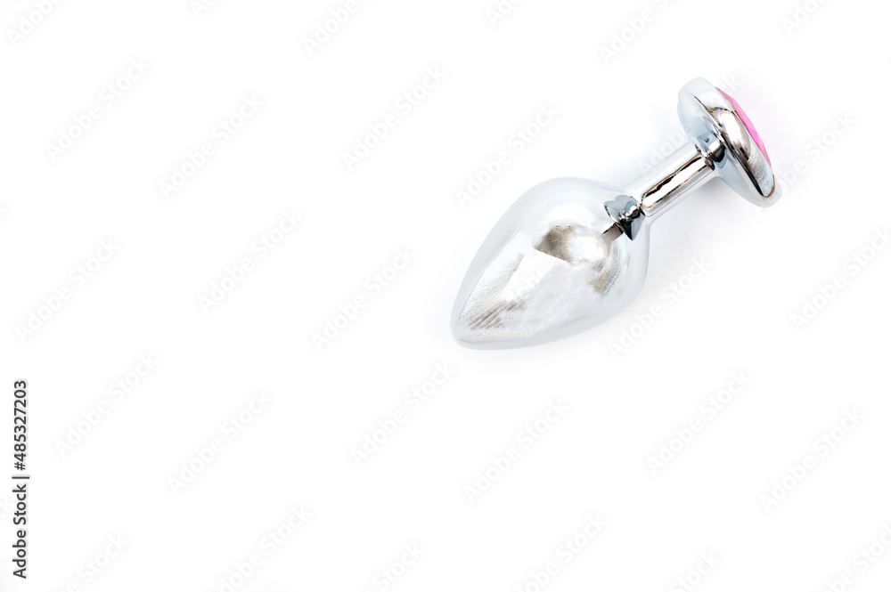 Metal butt plug with a decorative pink heart-shaped stone at the end. Metal butt plug with a decorative pink heart-shaped stone at the end.