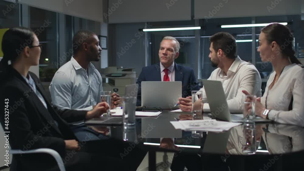 Multiethnic business colleagues discuss financial strategy having meeting in office