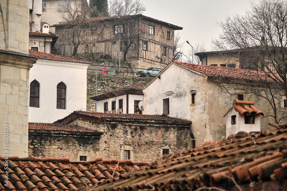 Many type of ottoman houses in Safranbolu turkey during rainy and foggy day. Low angle photo of ancient ottoman city of UNESCO world heritage.