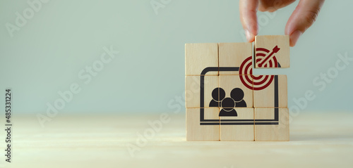 Contextual advertsing and targeting concept. Digital marketing strategy and social network advertsing. Personalized marketing. Hand holds the wooden cubes with goal and contextual advertising icons.