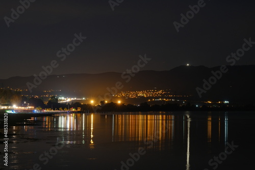 City lights and evening and city lights reflection on water ground lake of iznik.
