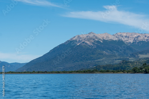 View of the Lake in the mountains in spring. Patagonian Coast Lake. Waves on the coast. Peninsula. Vertical Panoramic View. Vertical photo. 