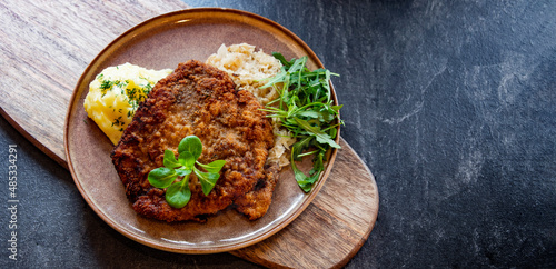 Pork breaded cutlet coated with breadcrumbs with mashed potatoes photo