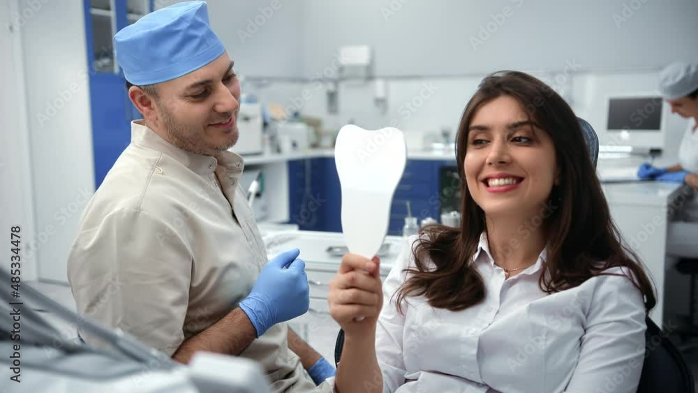 Happy woman dentistry patient checking result teeth whitening treatment satisfied mirror clinic Happy woman dentistry patient checking result teeth whitening treatment satisfied mirror clinic