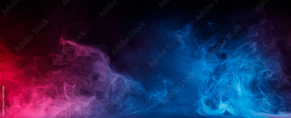 Abstract colored smoke moves on black background. Mystical swirling smoke rolling low across the ground. Abstract colored smoke moves on black background. Mystical swirling smoke rolling low across the ground.