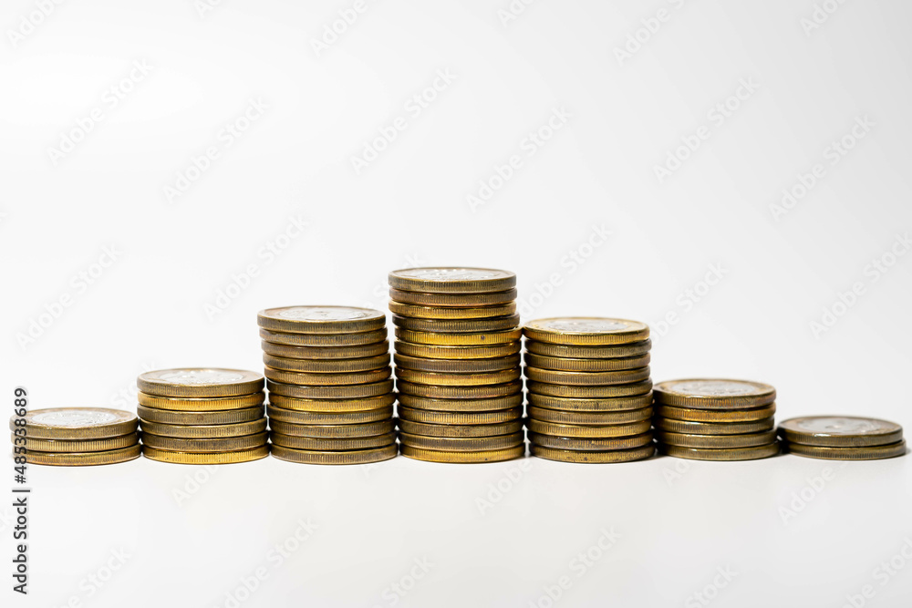 Increasing and decreasing pile of coins going up close up Increasing and decreasing pile of coins going up close up