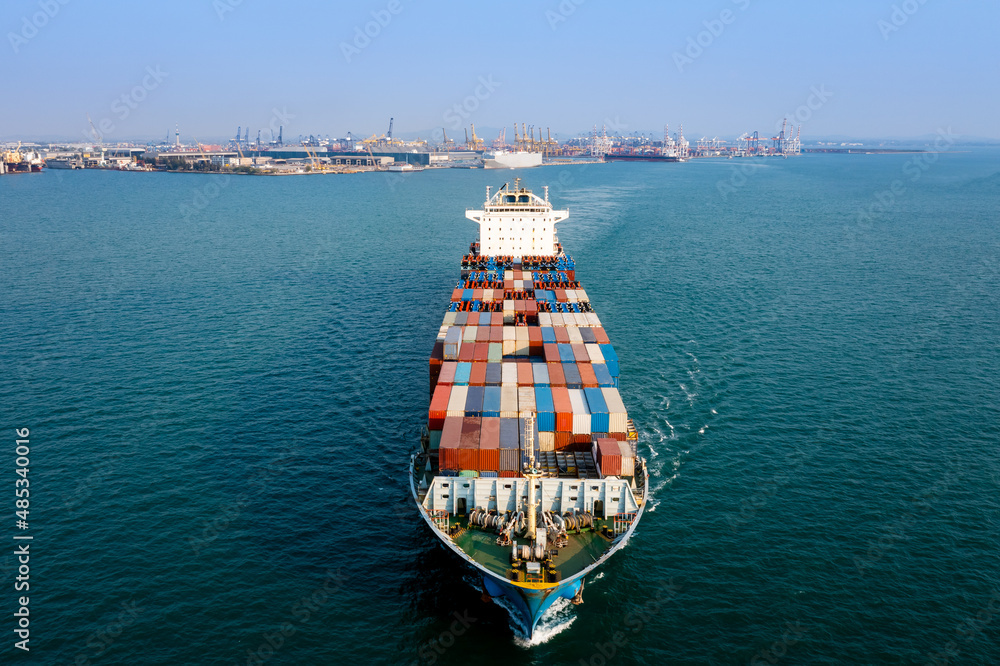 Aerial front view container cargo ship carrying commercial container import export business delivery service commerce cargo logistic and transportation international by container ship in sea