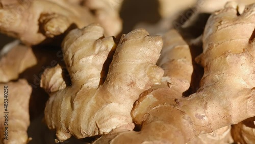 Whole ginger root on close up rotating 4K photo