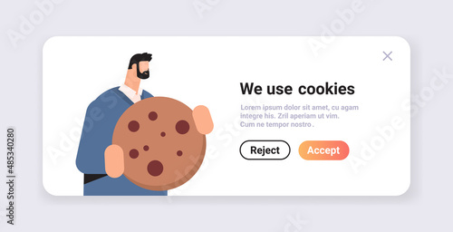 businessman holding cookie protection of personal information internet web pop up we use cookies policy notification