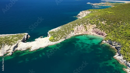 Aerial drone video of famous small bay of Agalipa with crystal clear emerald sea featuring iconic wooden shipwreck left ashore, Skyros island, Sporades, Greece photo
