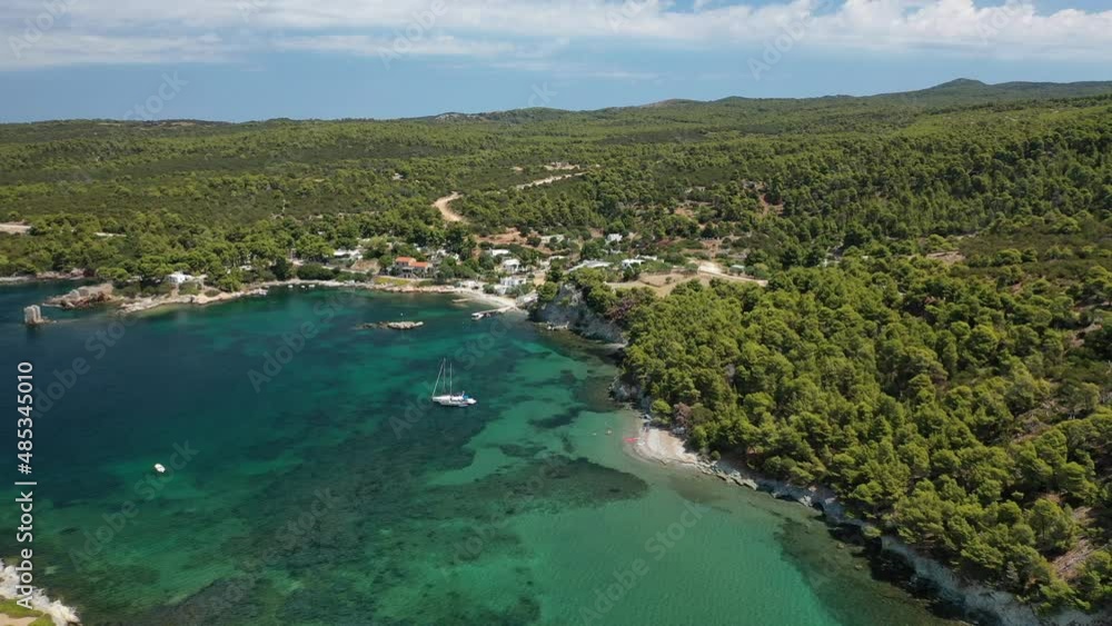 Aerial drone video of famous bay and small traditional village of Atsitsa covered in pine trees and natural sandy beaches, Skyros island, Sporades, Greece Aerial drone video of famous bay and small traditional village of Atsitsa covered in pine trees and natural sandy beaches, Skyros island, Sporades, Greece