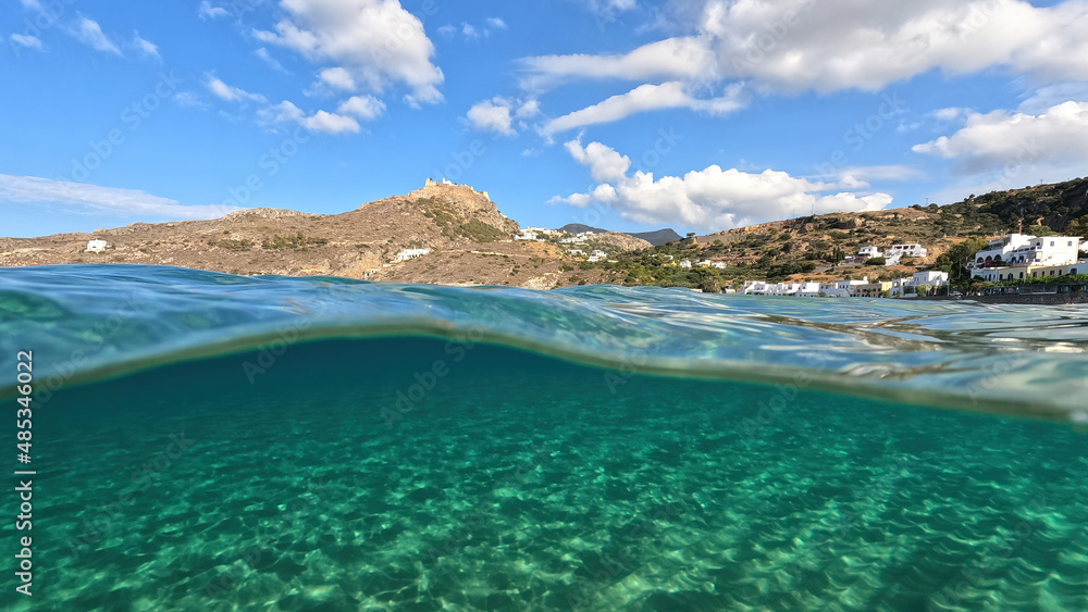 Underwater split photo taken from beautiful emerald bay and beach of Kapsali overlooking famous castle of Kythira island, Ionian, Greece