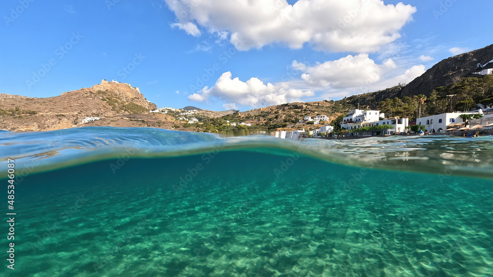 Underwater split photo taken from beautiful emerald bay and beach of Kapsali, Kythira island, Ionian, Greece